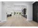 Spacious living room with hardwood floors, coffered ceilings, and large windows with backyard views at 407 Thunder Rd, Buford, GA 30518