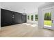Bright living room featuring hardwood floors, recessed lighting, a modern chandelier, and a black accent wall at 407 Thunder Rd, Buford, GA 30518