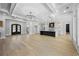 Open-concept area featuring hardwood floors, large windows, a fireplace, and an island kitchen at 407 Thunder Rd, Buford, GA 30518