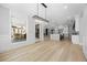 Open floor plan showcasing the modern kitchen with large island and view to outdoor living area at 407 Thunder Rd, Buford, GA 30518