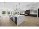 Open-concept kitchen and living room area with elegant lighting and hardwood floors at 407 Thunder Rd, Buford, GA 30518