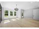 A modern living room with large windows and hardwood floors, offering a bright and airy atmosphere at 407 Thunder Rd, Buford, GA 30518