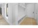 A mudroom area with a custom storage bench and hooks, providing a functional space at 407 Thunder Rd, Buford, GA 30518