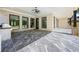 Spacious covered patio with outdoor kitchen, brick columns, and tiled floors at 407 Thunder Rd, Buford, GA 30518