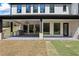 Covered patio with outdoor grill, stone columns and tiled floor of new construction home at 407 Thunder Rd, Buford, GA 30518