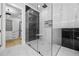 Modern walk-in shower featuring black-framed glass and marble tile, providing a luxurious bathing experience at 407 Thunder Rd, Buford, GA 30518