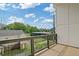 View from balcony reveals well-maintained green spaces, mature trees, and a clear blue sky at 1227 Cushenberry Ln, Atlanta, GA 30318