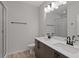 Bathroom featuring double sink vanity, framed mirror, walk-in shower with a glass door at 1227 Cushenberry Ln, Atlanta, GA 30318