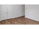 Bedroom with wood-look flooring, white walls, base trim and double closets at 1227 Cushenberry Ln, Atlanta, GA 30318