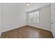 Bright bedroom featuring hardwood floors, window with blinds and white trim at 1227 Cushenberry Ln, Atlanta, GA 30318