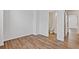 Bedroom featuring view into bathroom, wood-look floors, and white base trim at 1227 Cushenberry Ln, Atlanta, GA 30318