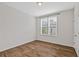 Empty bedroom featuring hardwood floors, a double hung window, and white walls at 1227 Cushenberry Ln, Atlanta, GA 30318