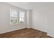 Bedroom featuring wood-look floors, base trim and window with blinds at 1227 Cushenberry Ln, Atlanta, GA 30318