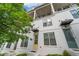 Modern townhome featuring brick, white siding, black accents, and a second story balcony at 1227 Cushenberry Ln, Atlanta, GA 30318