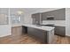 Open concept kitchen featuring stainless steel appliances, gray cabinets, and a spacious island at 1227 Cushenberry Ln, Atlanta, GA 30318