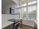 Stylish kitchen features stainless steel appliances, gray cabinetry, and ample countertop space at 1227 Cushenberry Ln, Atlanta, GA 30318