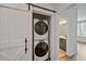 A stacked, front load washer and dryer is hidden behind a sliding barn door at 1227 Cushenberry Ln, Atlanta, GA 30318