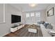 Modern living room with sleek furniture, TV, and wood flooring at 1227 Cushenberry Ln, Atlanta, GA 30318