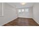 Bright living room with three large windows and wood flooring at 1227 Cushenberry Ln, Atlanta, GA 30318