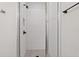 Tiled shower stall featuring glass door, matte black hardware, and built-in shelf at 1227 Cushenberry Ln, Atlanta, GA 30318