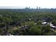 Aerial view of the area near the property showcasing tree coverage and access to city amenities in the distance at 1012 Bellevue Ne Dr, Atlanta, GA 30306