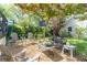 Charming backyard with a seating area, lush trees, and manicured lawn, perfect for relaxing and entertaining at 1012 Bellevue Ne Dr, Atlanta, GA 30306