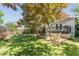 Lush backyard featuring mature trees, a stone pathway, a deck, and an outdoor dining area for relaxing enjoyment at 1012 Bellevue Ne Dr, Atlanta, GA 30306