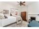 Cozy bedroom featuring a decorative ceiling fan, a vintage fireplace, and a large window offering natural light at 1012 Bellevue Ne Dr, Atlanta, GA 30306