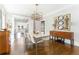 Open dining room with hardwood floors, stylish light fixture, and views into a modern kitchen at 1012 Bellevue Ne Dr, Atlanta, GA 30306