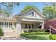 Charming home with a brick facade, lush landscaping, and inviting front porch, perfect for relaxing and enjoying the outdoors at 1012 Bellevue Ne Dr, Atlanta, GA 30306