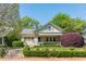 Charming home with manicured front yard landscaping including mature shrubs, flowerbeds, and stone stairs at 1012 Bellevue Ne Dr, Atlanta, GA 30306