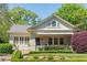 Charming home with a brick facade, lush landscaping, and inviting front porch, perfect for relaxing and enjoying the outdoors at 1012 Bellevue Ne Dr, Atlanta, GA 30306