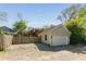 A one-car detached garage features exterior lighting, and a gravel driveway surrounded by a wooden fence at 1012 Bellevue Ne Dr, Atlanta, GA 30306