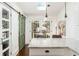 Bright kitchen features granite counters, white cabinets, skylight, and a reclaimed barn door at 1012 Bellevue Ne Dr, Atlanta, GA 30306