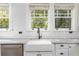Bright kitchen featuring a white apron-front sink, subway tile backsplash, and bronze fixtures at 1012 Bellevue Ne Dr, Atlanta, GA 30306