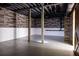 Unfinished basement with white-painted drywall, dark ceilings, and wood-paneled wall at 186 Majesty Dr, Rockmart, GA 30153