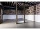 Spacious unfinished basement featuring exposed beams and wood accent wall at 186 Majesty Dr, Rockmart, GA 30153