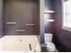 Contemporary bathroom features large soaking tub, floating shelves and modern finishes at 186 Majesty Dr, Rockmart, GA 30153