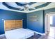 Primary bedroom features wood-look flooring, tray ceilings and contemporary fixtures at 186 Majesty Dr, Rockmart, GA 30153