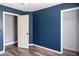 Bedroom featuring dark blue painted walls and hardwood flooring at 186 Majesty Dr, Rockmart, GA 30153