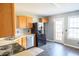 Compact kitchen with black appliances, wood cabinets, and a view to the backyard at 186 Majesty Dr, Rockmart, GA 30153