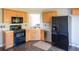 Functional kitchen layout with black appliances, wood cabinets, and countertops at 186 Majesty Dr, Rockmart, GA 30153