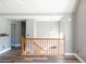 Open living area with wood floors, neutral walls, and wood railing at 186 Majesty Dr, Rockmart, GA 30153