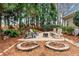 Backyard with fire pit, seating, and mature trees surrounding the space at 2407 Honey Ct, Mcdonough, GA 30252