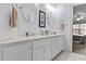 Bright bathroom with a dual sink vanity, neutral walls, and a view to the bedroom at 2407 Honey Ct, Mcdonough, GA 30252