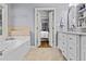 Bathroom with a large soaking tub and double doors that lead to the primary bedroom at 2407 Honey Ct, Mcdonough, GA 30252