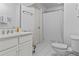 Bright white bathroom featuring a shower with curtain, toilet, and vanity sink at 2407 Honey Ct, Mcdonough, GA 30252
