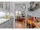 Butler pantry with white cabinets, quartz countertops, and serving area at 2407 Honey Ct, Mcdonough, GA 30252
