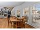 Dining room boasts hardwood floors, wooden table set and an abundance of natural light from the large windows at 2407 Honey Ct, Mcdonough, GA 30252