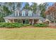 Charming home featuring a well-manicured lawn, covered porch, and dormer windows at 2407 Honey Ct, Mcdonough, GA 30252
